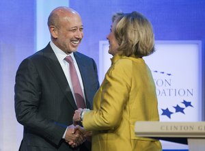 Lloyd Blankfein, left, Chairman and CEO of Goldman Sachs, is greeted by Hillary Rodham Clinton, former Secretary of State, for a panel discussion, "Equality for Girls and Women: 2034 Instead of 2134?" at the Clinton Global Initiative, Wednesday, Sept. 24, 2014 in New York.