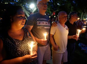 Supporters of the victims of the recent mass shooting at the Pulse nightclub attend a vigil at Lake Eola Park, Sunday, June 19, 2016, Orlando, Fla. Tens of thousands of people attended the vigil.