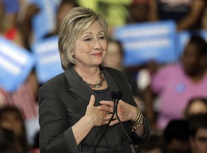 Democratic presidential candidate Hillary Clinton gestures as she "sighs" talking about Republican presidential candidate Donald Trump during a rally in Raleigh, N.C., Wednesday, June 22, 2016.