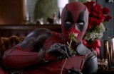 A still from an ad for "Deadpool," showing the title character holding a rose