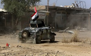 Iraqi Counterterrorism force advance their positions in Fallujah, Iraq, Wednesday, June 22, 2016. Pockets of Islamic State fighters continue to hold neighborhoods along the north and west of the city