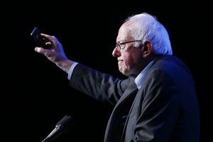 Democratic presidential candidate Sen. Bernie Sanders, I-Vt., holds up an Apple iPhone while speaking during a fundraiser at the Avalon Hollywood, Wednesday, Oct. 14, 2015, in Hollywood, Calif.