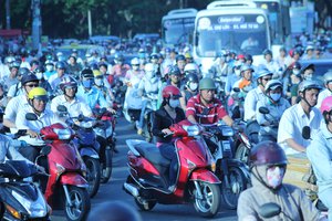 File - Thousands of scooters make their way through Ho Chi Minh City, Vietnam. Concern about human overpopulation and resource consumption is a growing global problem.