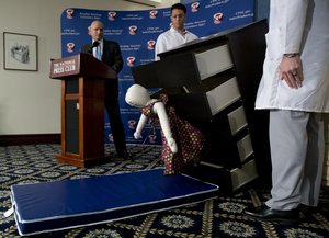 Consumer Product Safety Commission (CPSC) Chairman Elliot Kaye, left, watches a demonstration of how an Ikea dresser can tip and fall on a child during a news conference at the National Press Club in Washington