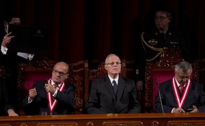 Peru's President Pedro Pablo Kuczynski, center, looks to the crowd next to Francisco Tavara, president of the National Office of Electoral Processes, right, and Jesus Fernandez Alarcon, left, after receiving his credentials from the National Office of Electoral Processes in Lima, Peru, Tuesday, June 28, 2016.