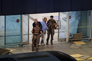 Turkish police officers stand outside Istanbul's Ataturk airport, late Tuesday, June 28, 2016.