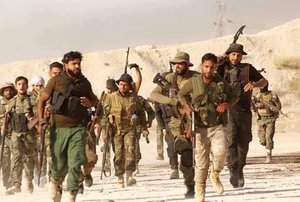 This photo released on Tuesday June 28, 2016, provided by the New Syrian Army anti-government rebels, which has been authenticated based on its contents and other AP reporting, shows U.S.-backed Syrian rebels of the New Syrian Army run at unknown place in Syria. Islamic State militants on Wednesday pushed back U.S.-trained Syrian rebels from the outskirts of a town on the Iraqi border