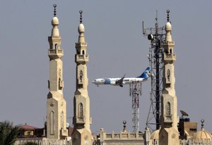 An EgyptAir flight plane flies in front of minarets of a mosque as it prepares for landing near Cairo airport, in Cairo, May, 21, 2016.