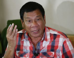 Front-running presidential candidate Mayor Rodrigo Duterte gestures during his second news conference after voting in a polling precinct at Daniel R. Aguinaldo National High School, Matina district, his hometown in Davao city in southern Philippines Monday, May 9, 2016.