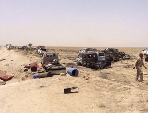 Iraqi security forces inspect vehicles belonging to escaping Islamic State militants destroyed by U.S.-led coalition warplanes outside Fallujah, Iraq