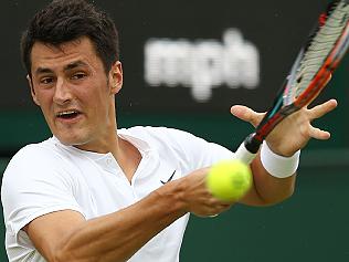 Australia's Bernard Tomic returns to Spain's Fernando Verdasco during their men's singles first round match on the third day of the 2016 Wimbledon Championships at The All England Lawn Tennis Club in Wimbledon, southwest London, on June 29, 2016. / AFP PHOTO / JUSTIN TALLIS / RESTRICTED TO EDITORIAL USE