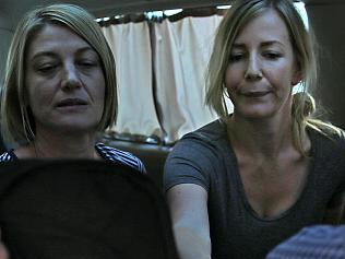 UPLOADED IMAGE - Australian TV journalist Tara Brown, left, and Sally Faulkner, right, the mother of the two Australian children, sit in a minivan after they released from a Lebanese jail with the three members of Channel 9 Australian TV crew, in Baabda east of Beirut, Lebanon, Wednesday April 20, 2016. An Australian mother and TV crew caught up in a high-profile child custody battle and detained in Beirut amid a botched attempt to take the woman's two children from their Lebanese father have been released on bail. (AP Photo/Hussein Malla)