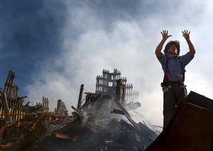 File - A New York City fireman calls for 10 more rescue workers to make their way into the rubble of the World Trade Centre., 15 September, 2011.