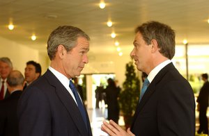 File - President George W. Bush, United States and Prime Minister Tony Blair, United Kingdom, at a Heads of State and Government prior to the NATO-Russia Council, 28 May 2002.