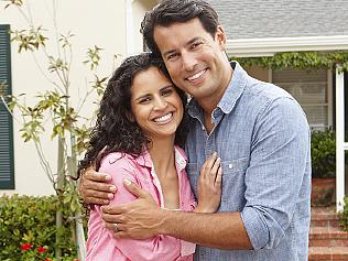 Hispanic couple outside home