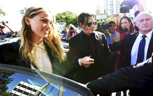 Johnny Depp, center, and wife Amber Heard, left, arrive at the Southport Magistrates Court on the Gold Coast, Australia, Monday, April 18, 2016.