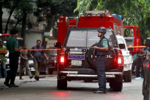 Bangladeshi security officers cordon off an area after heavily armed militants attacked a restaurant in Bangladesh's diplomatic zone on Friday night, in Dhaka, Bangladesh