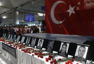 In this Thursday, June 30, 2016 photo, family members, colleagues and friends of the victims of Tuesday blasts gather for a memorial ceremony at the Ataturk Airport in Istanbul