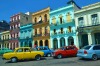 Colourful cars parked in front of historic buildings in Havana, Cuba.