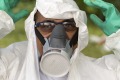 A municipal health worker prepares to spray insecticide on Monday in a junk yard in Joao Pessoa, Brazil, to combat the ...