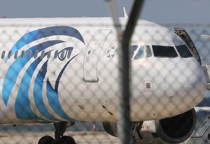 A crew member of the hijacked aircraft of EgyptAir is seen on the passenger steps after landing at Larnaca airport Tuesday, March 29, 2016.