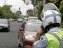 24/01/05   139736dSenior Constable Andy Gray looks out for speeding motorists in Primary School Court, outside Maroochydore Primary School, as part of operation Back to School.Photo: Brett Wortmantraffic offence ticket fine police