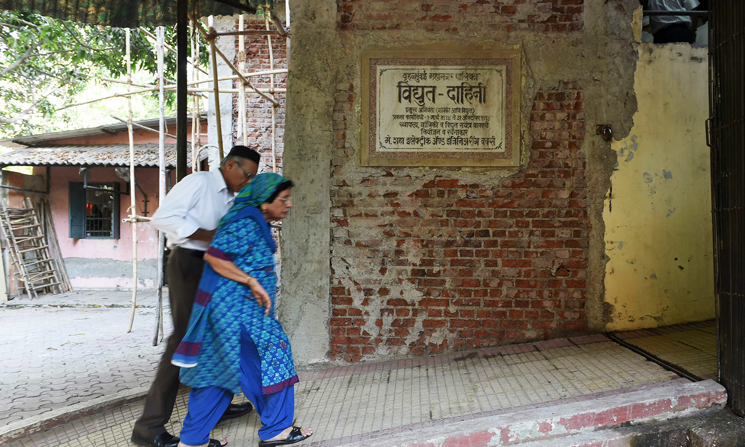 In this photo taken on May 10, 2016, a Parsi couple enters an electric crematorium to attend the last rites of a member of the community at a prayer hall in Mumbai.