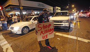 Protestors congregate at N. Foster Dr. and Fairfields Ave., the location of the Triple S convenience store in Baton Rouge, La., Wednesday, July 6, 2016. Alton Sterling, 37, was shot and killed outside the store by Baton Rouge police, where he was selling CDs.