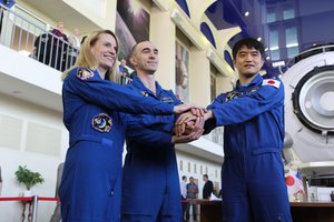 At the Gagarin Cosmonaut Training Center in Star City, Russia, Expedition 48-49 prime crewmembers Kate Rubins of NASA (left), Anatoly Ivanishin of Roscosmos (center) and Takuya Onishi of the Japan Aerospace Exploration Agency (right) pose for pictures May 26 during a final qualification exam session