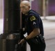 A Dallas policeman keeps watch on a street in downtown Dallas,