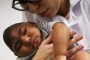 A Brazilian doctor performs physical therapy on an infant born with microcephaly, a birth defect linked to the Zika virus.