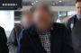 The two suspects, with their faces obscured here, arrive at Sydney Airport, escorted by police.