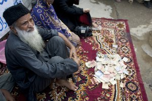 FILE - In this Monday, Aug. 2, 2010 file photo, Pakistan's humanitarian leader Abdul Sattar Edhi collects donations at a roadside in Peshawar, Pakistan. The family of Pakistan's legendary philanthropist Abdul Sattar Edhi says he has died at a hospital in Karachi. (AP Photo/Anjum Naveed, File)