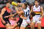 MELBOURNE, AUSTRALIA - JULY 03:  Daniel Talia of the Crows handballs whilst being tackled by Tomas Bugg of the Demons   ...