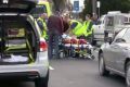 Paramedics attend to the injured boy in Main Street, Bairnsdale, on Saturday.