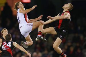 One step beyond: Saint Josh Bruce competes for the ball with Essendon's Shaun McKernan in St Kilda's win at Etihad on ...