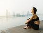 Relaxed young yoga woman in yoga pose near pool. Thinkstock image