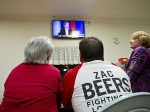 Zac Beers supporters' Shelly Holzheimer mayor Matt Burnett have their eyes firmly focused on the TV screen.