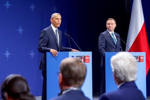 U.S. Secretary of State John Kerry and U.S. Defense Secretary Ash Carter look on from the audience as President Obama makes remarks on July 8, 2016, at the National Stadium in Warsaw, Poland, during a joint statement with Polish President Andrzej Duda following a bilateral meeting on the sidelines of the NATO Summit.