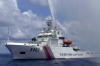 A Chinese Coast Guard boat sprays a water cannon at Filipino fishermen near Scarborough Shoal in the South China Sea ...