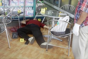 Kem Ley body,  a political analyst, lays on the floor in local mart, in Phnom Penh, Cambodia