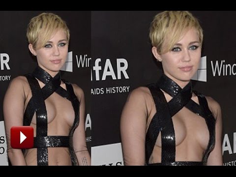 Miley Cyrus Covers BOOBS With Only Black Straps At Charity Event