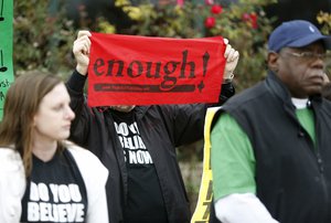 A protester holds a sign at a press conference in front of city hall in North Charleston, S.C., Friday, Jan 8, 2016, in the wake of the release of former North Charleston police officer Michael Slager on bond.