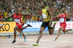 Jamaica's Usain Bolt, right, wins the gold medal in the men's 100m ahead of United States' Justin Gatlin, left, at the World Athletics Championships at the Bird's Nest stadium in Beijing, Sunday, Aug. 23, 2015.