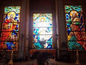 Calaruega church altar is decorated with colorful capiz images of Jesus Christ and saints.