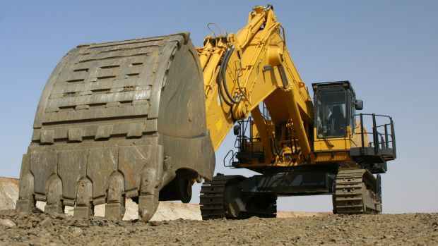 Excavator parked in an open cast pit at change of shift