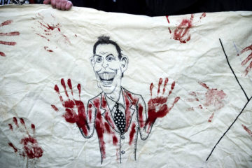 Banner depicts Tony Blair's bloody hands, from Stop the War Demonstration, QEII Conference Centre, London. (Photo by lewishamdreamer on Flickr)