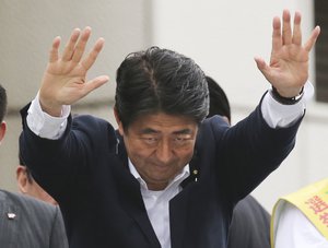 File - Japanese Prime Minister and ruling Liberal Democratic Party (LDP) president Shinzo Abe waves during a last day of the official campaigning for the House of Councillors election in Tokyo, Saturday, July 9, 2016.