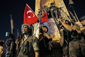 Turkish soldiers secure Istanbul's Taksim square, as supporters of Turkey's President Recep Tayyip Erdogan, protest in Istanbul's Taksim square, early Saturday, July 16, 2016. Turkey's prime minister says a group within Turkey's military has engaged in what appeared to be an attempted coup. Binali Yildirim told NTV television: "it is correct that there was an attempt." (AP Photo/Emrah Gurel)