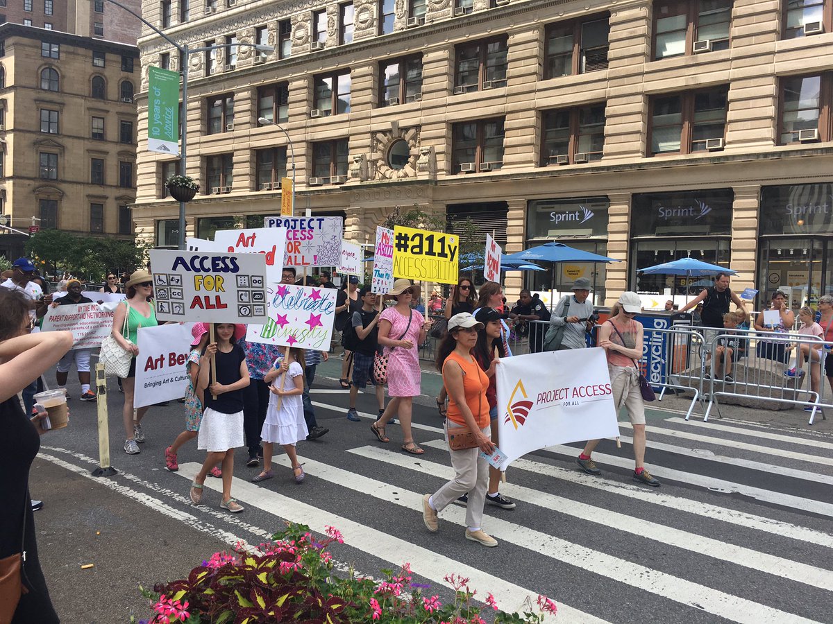 Parade participants from Project Access holding signs "Access For All"